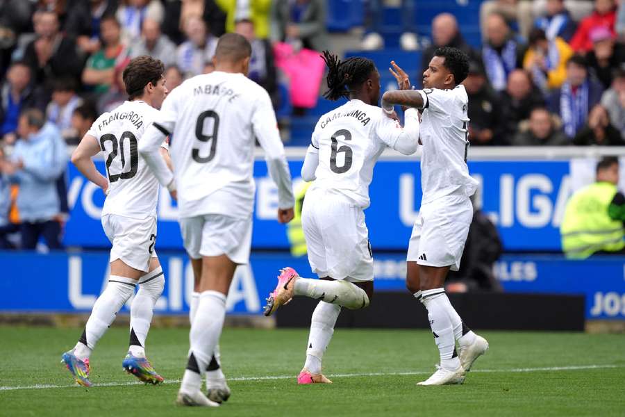 Real Madrid players including Rodrygo and Camavinga celebrating Real Madrid 2-1 Alaves victory.
