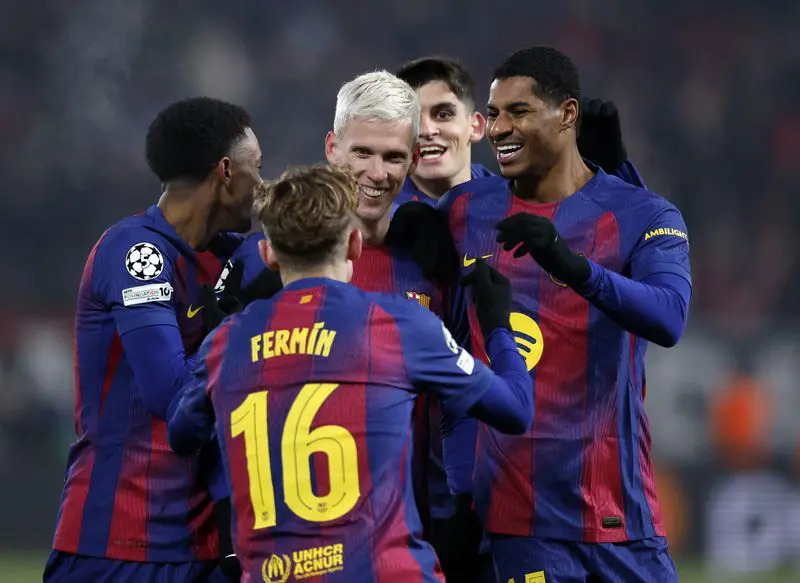 Fermin Lopez, Dani Olmo, and Marcus Rashford celebrating a goal for Barcelona against Slavia Prague.
