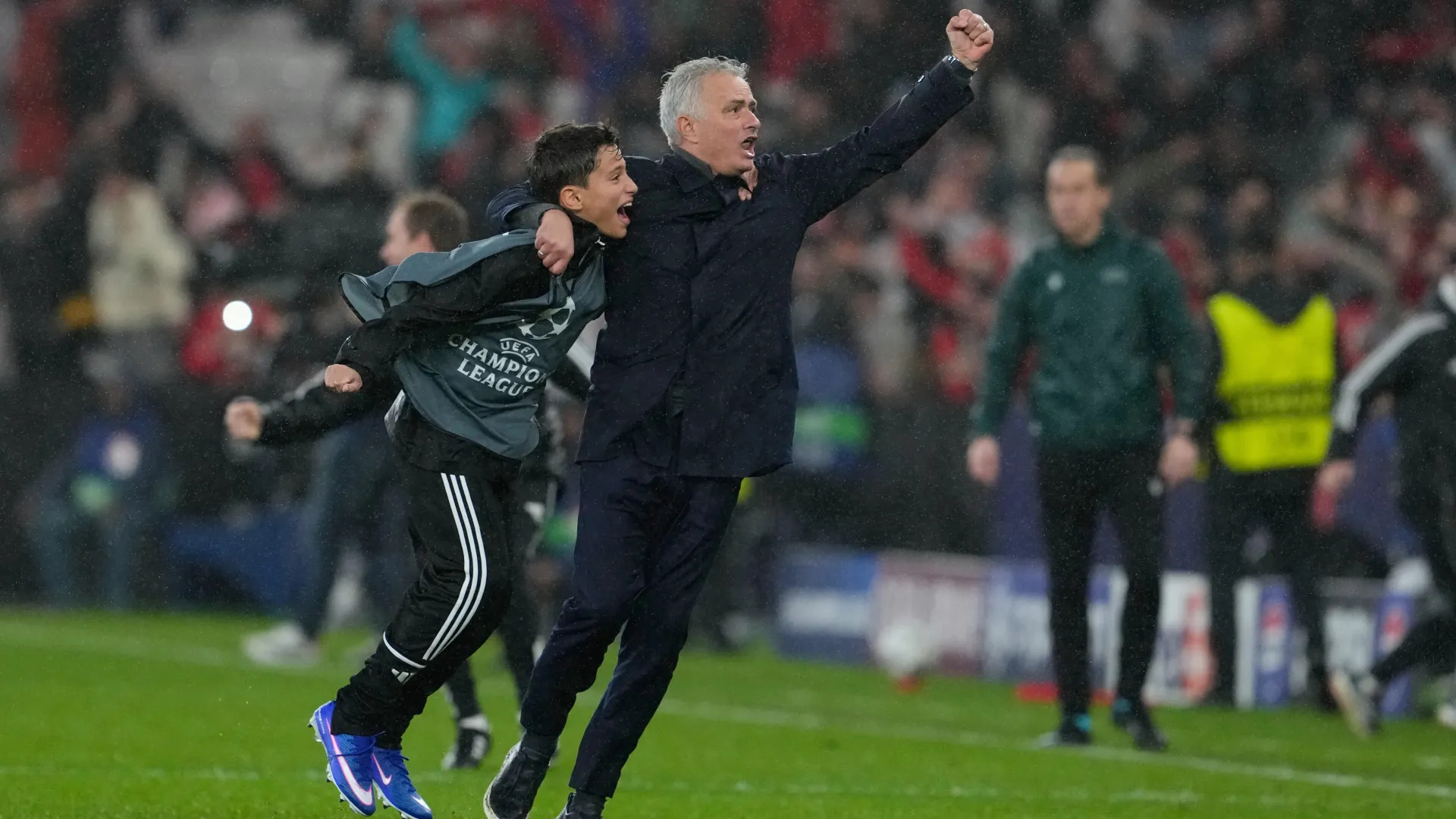 Jose Mourinho celebrates wildly with a ball boy after Benfica's dramatic 4-2 win over Real Madrid in the Champions League.