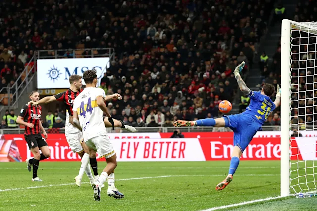 Lecce goalkeeper Wladimiro Falcone making a diving save against an AC Milan volley.