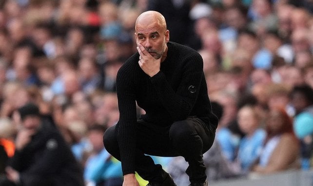 Manchester City manager Pep Guardiola watches intensely from the touchline as his team fights for a Champions League Top 8 spot.
