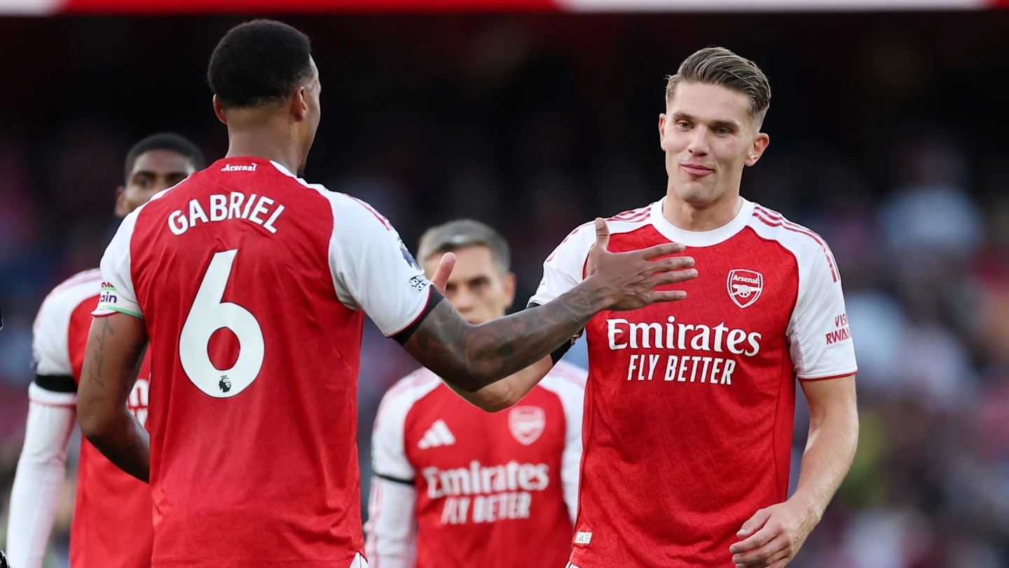 Arsenal vs Man City title race relies on defense as Gabriel Magalhaes celebrates a stop.