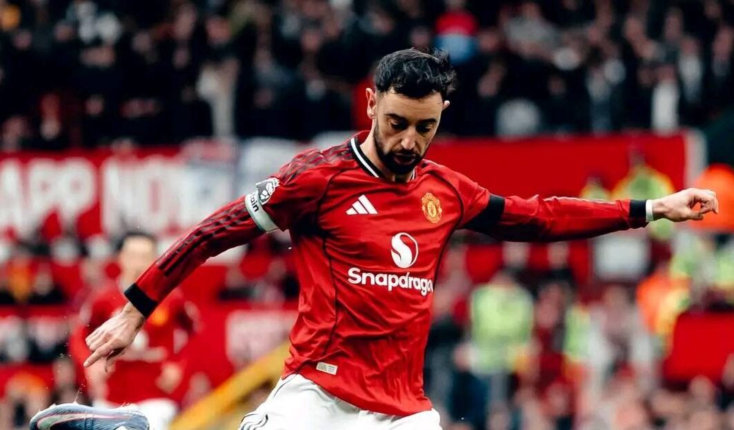 Bruno Fernandes strikes the ball with perfect technique during a Manchester United match, showcasing his playmaking ability.