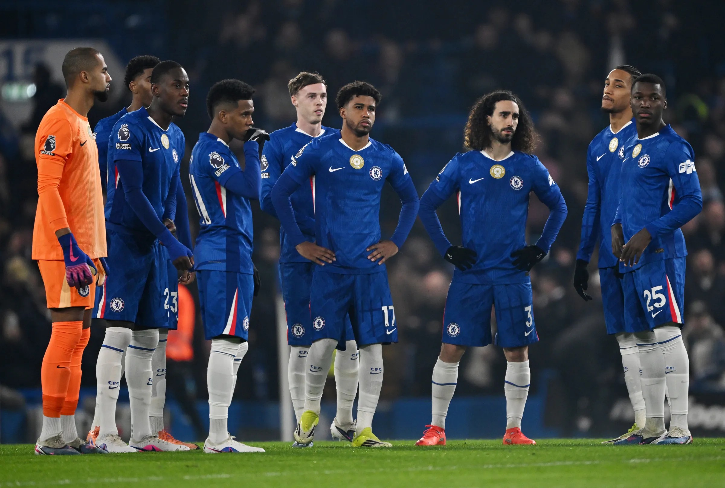 Chelsea players including Marc Cucurella and Moises Caicedo look dejected and frustrated with hands on their hips after surrendering their lead.