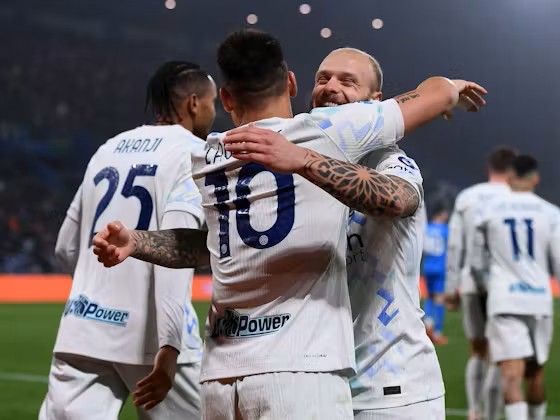 Inter Milan players embracing during a Serie A match celebration.